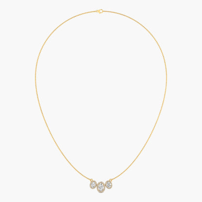 Gold necklace with a small pendant on a light gray background