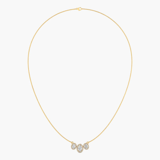 Gold necklace with a small pendant on a light gray background