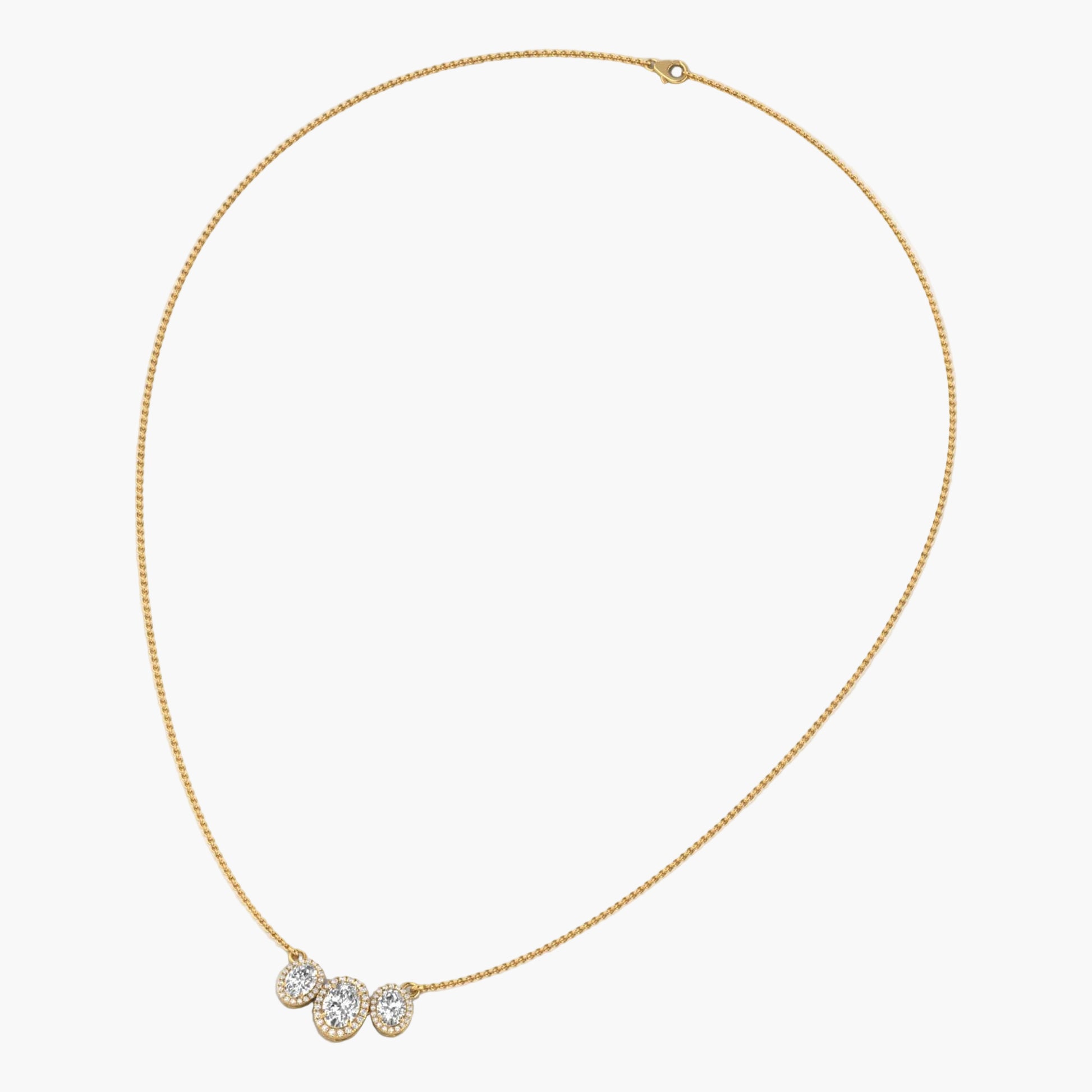 Gold necklace with three round pendants on a white background