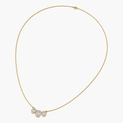 Gold necklace with three round pendants on a white background