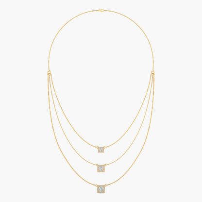 Gold necklace with square pendant on a white background