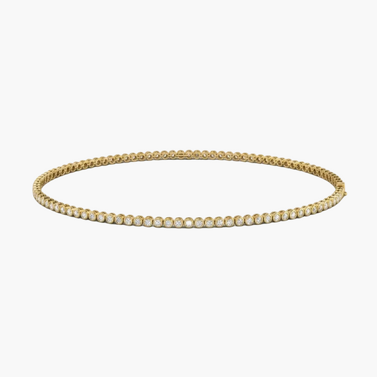 Gold necklace with clear gemstones on a white background
