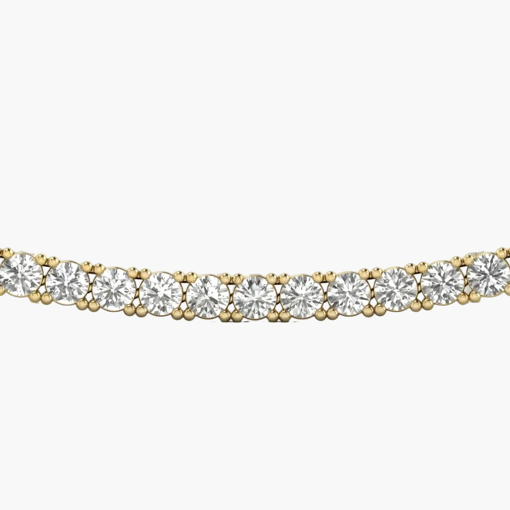 Gold necklace with clear gemstones on a white background