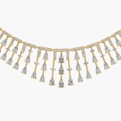 Gold and diamond fringe necklace on a white background