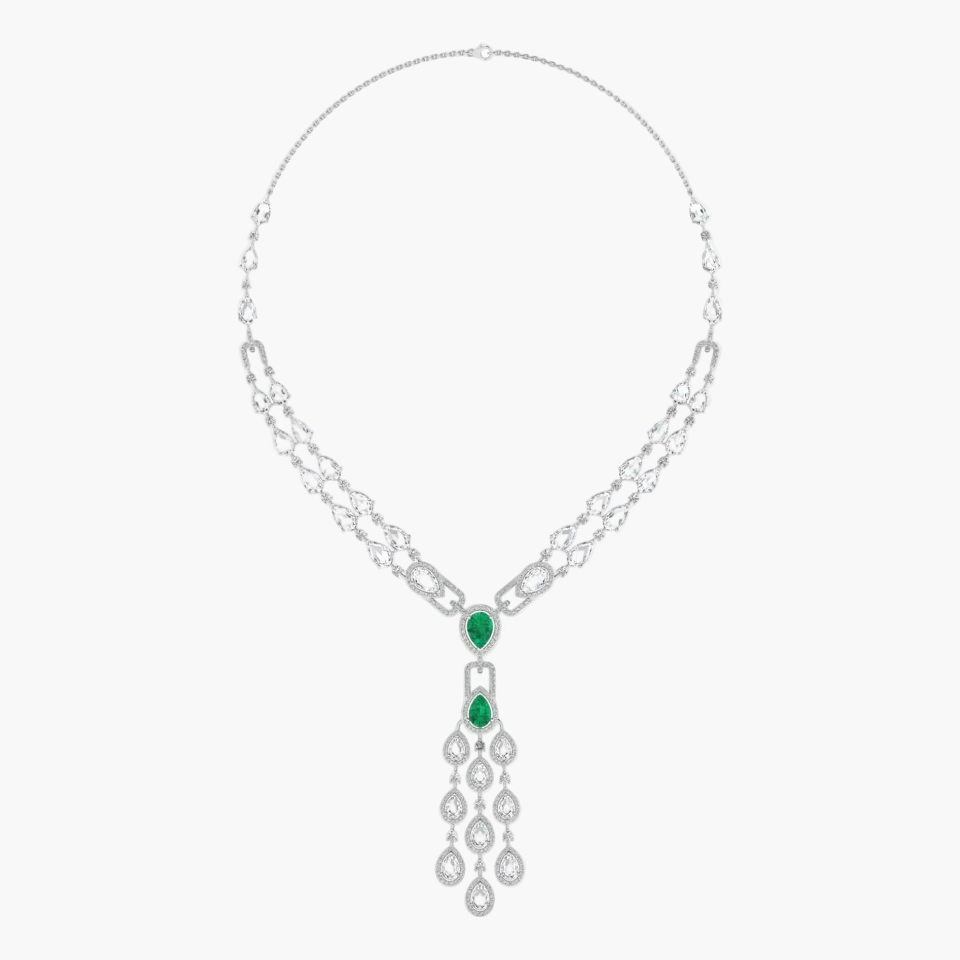 Silver necklace with emerald green gemstones on a white background