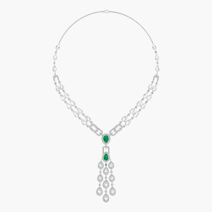 Silver necklace with emerald green gemstones on a white background