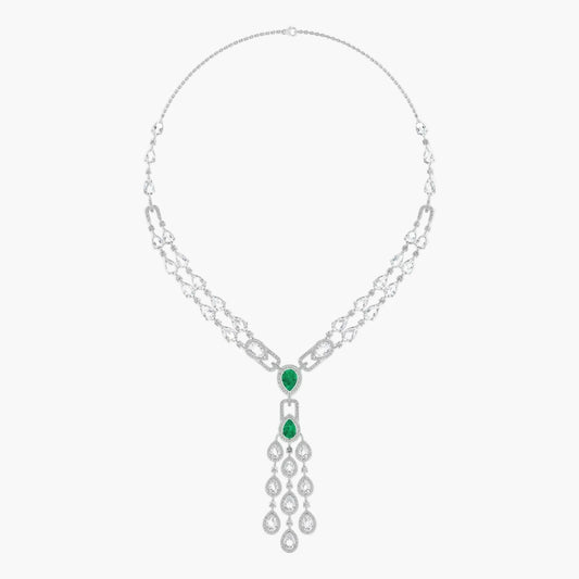 Silver necklace with emerald green gemstones on a white background