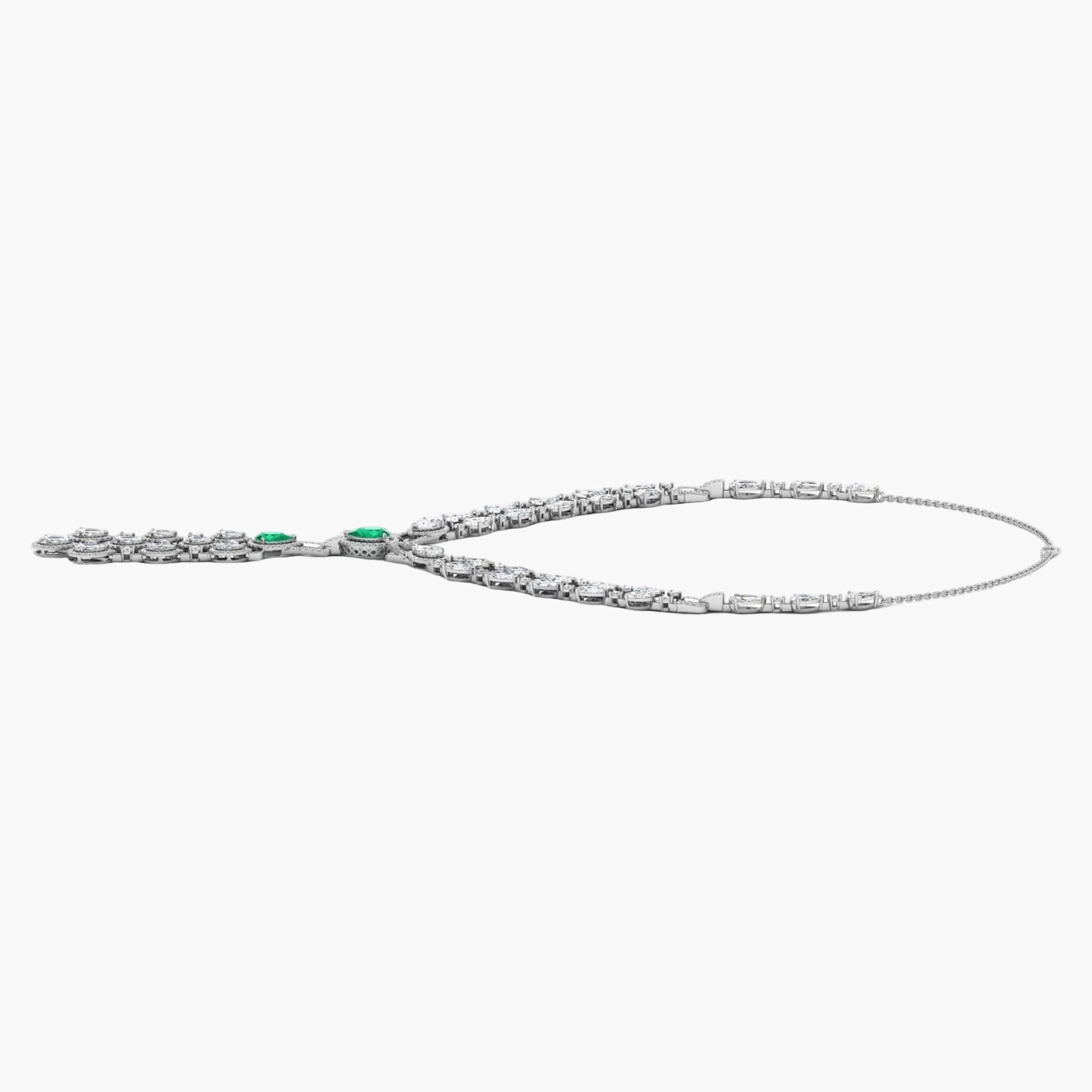 Silver necklace with green gemstones on a white background