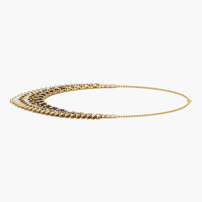 Gold necklace with blue stones on a white background