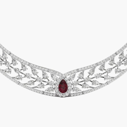 Elegant necklace with a central red gemstone on a white background
