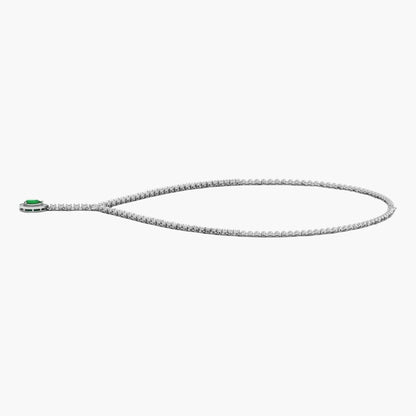 Silver necklace with a green gemstone on a white background