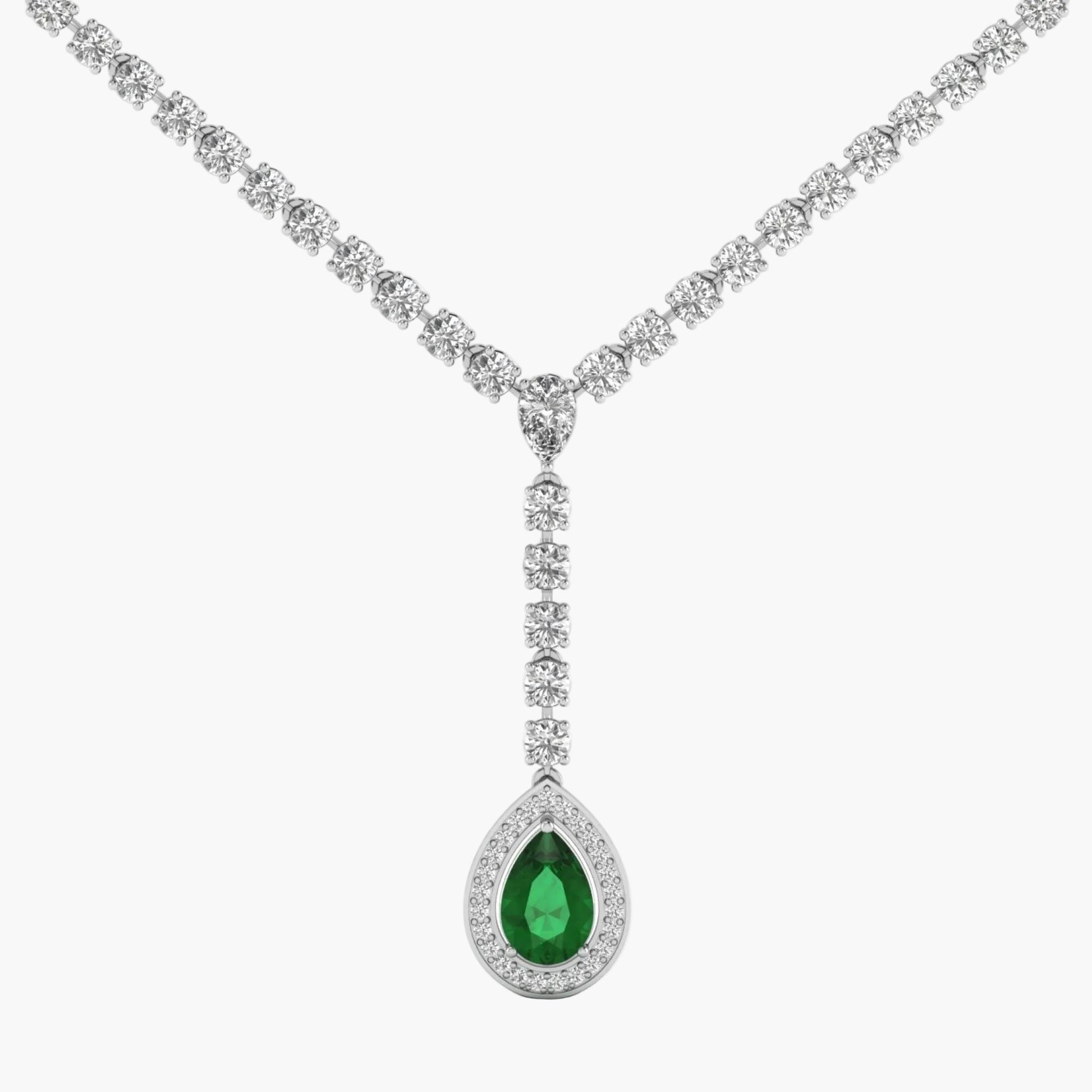 Diamond necklace with a green teardrop pendant on a white background