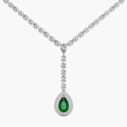 Diamond necklace with a green teardrop pendant on a white background