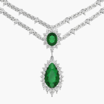 Elegant necklace with emerald green gemstones on a white background