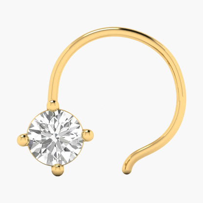 Gold nose ring with a clear gemstone on a white background