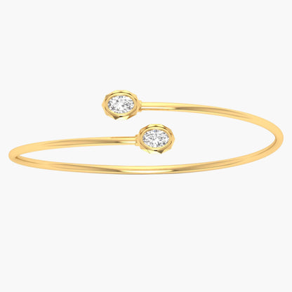 Gold bracelet with two diamond-like stones on a white background