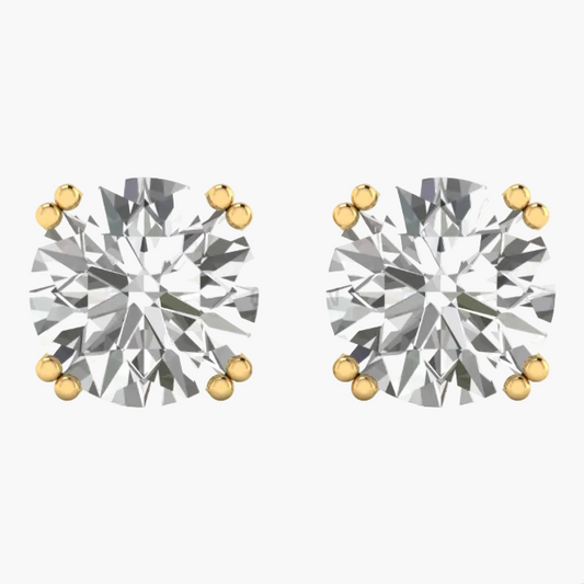 A pair of round-cut diamond stud earrings in yellow gold prong settings, shown on a plain white background with a faint GREENE LAB watermark.