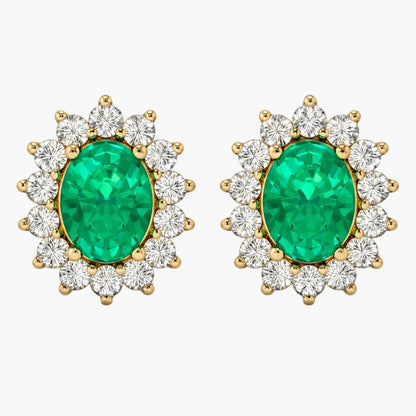 Pair of emerald and diamond earrings on a white background