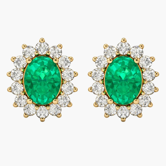 Pair of emerald and diamond earrings on a white background