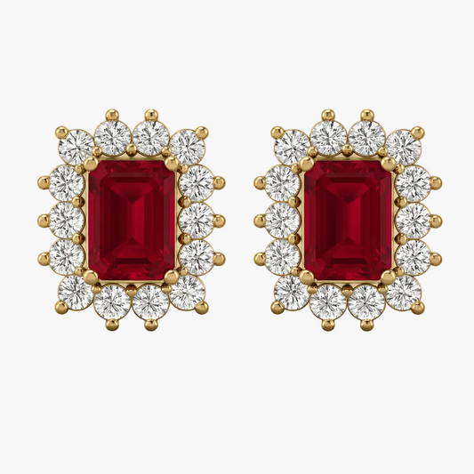 Pair of earrings with red gemstones and gold and diamond accents on a white background