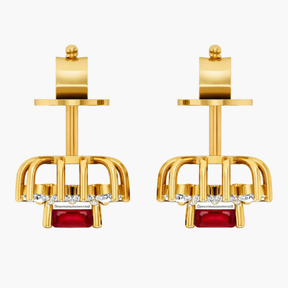 Gold earrings with red gemstones and clear stones on a white background