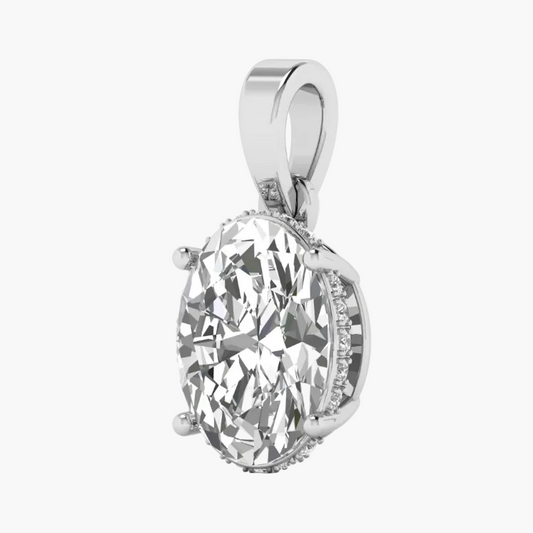 An oval-cut diamond pendant with a silver-toned setting and a halo of small accent diamonds, shown on a plain white background.