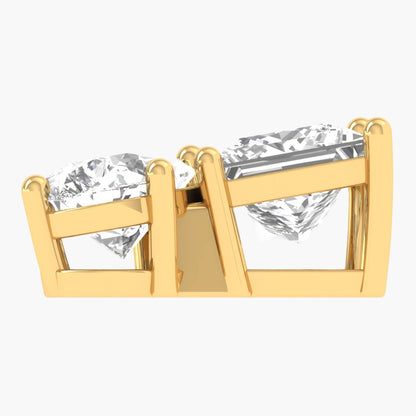 Gold earrings with clear gemstones on a white background