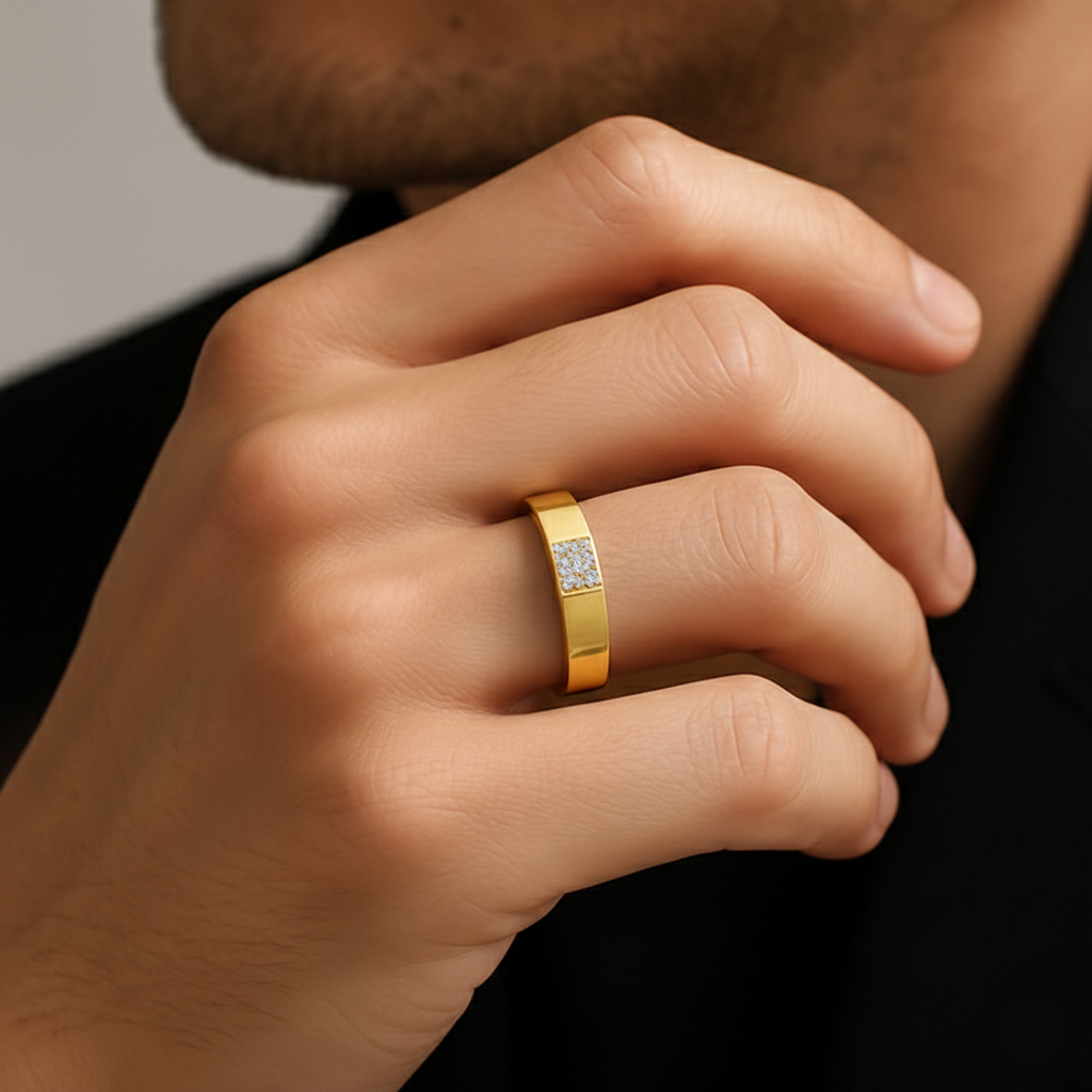 Gold ring with a diamond on a person's finger against a neutral background