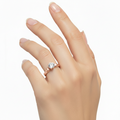Hand wearing a rose gold ring with a diamond on a white background