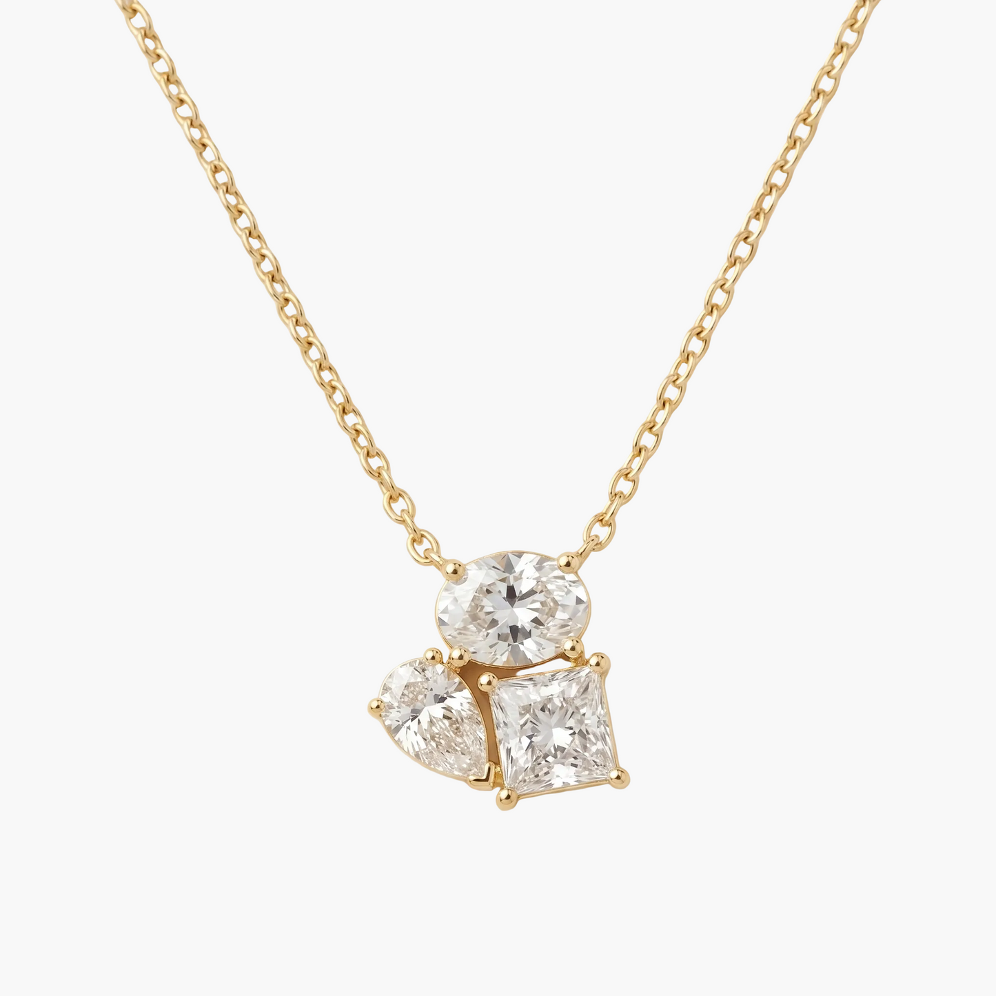 Gold necklace with a diamond pendant on a beige background