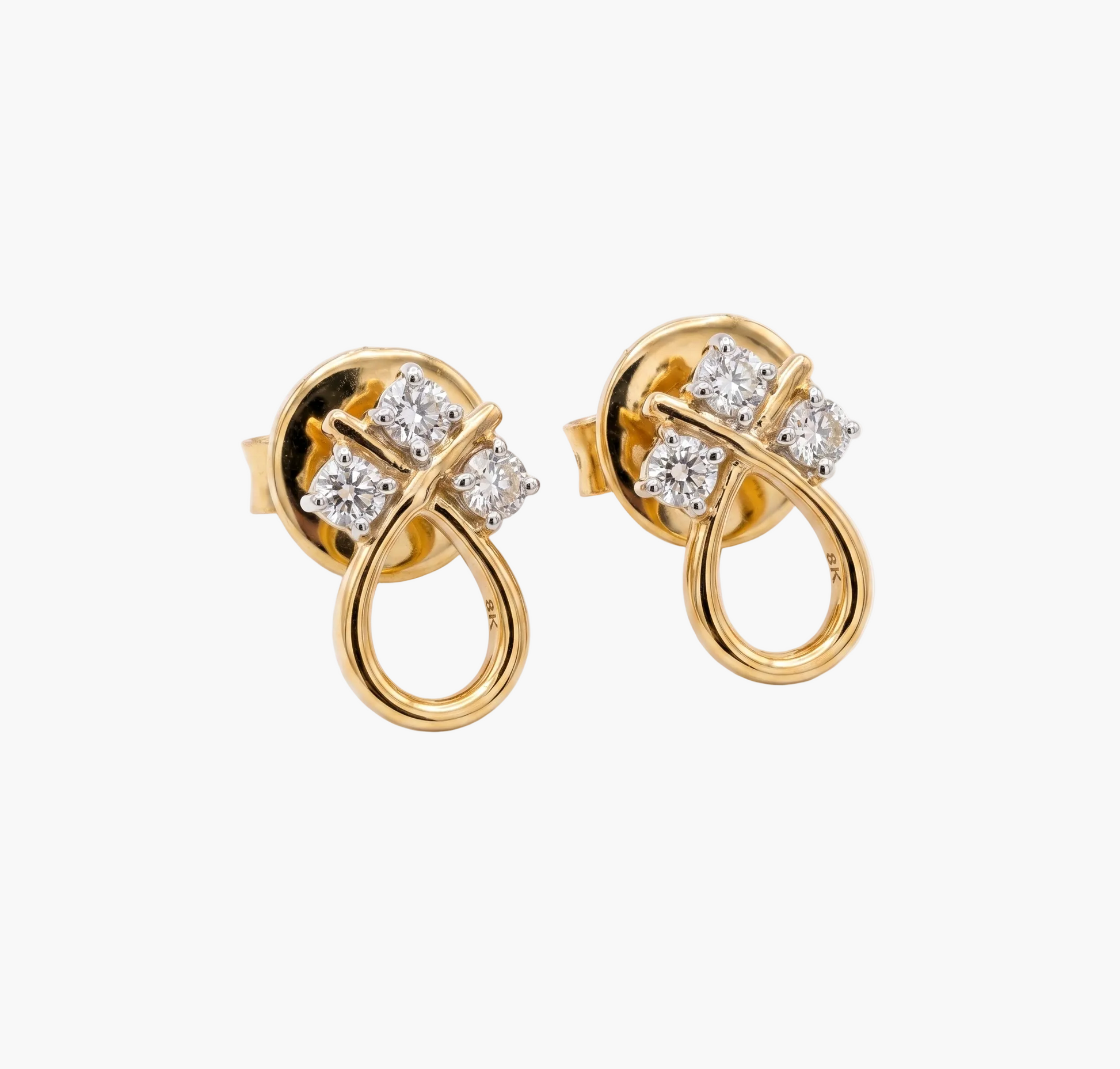 Gold earrings with diamond accents on a white background