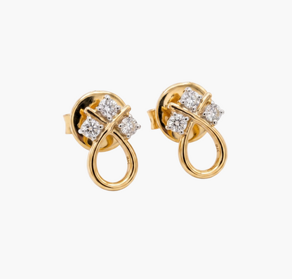 Gold earrings with diamond accents on a white background