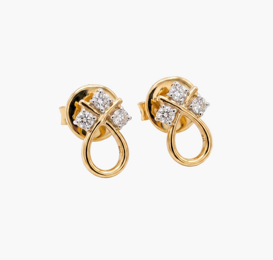 Gold earrings with diamond accents on a white background