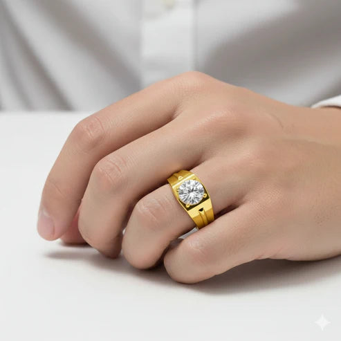 Gold ring with a diamond on a person's finger against a neutral background
