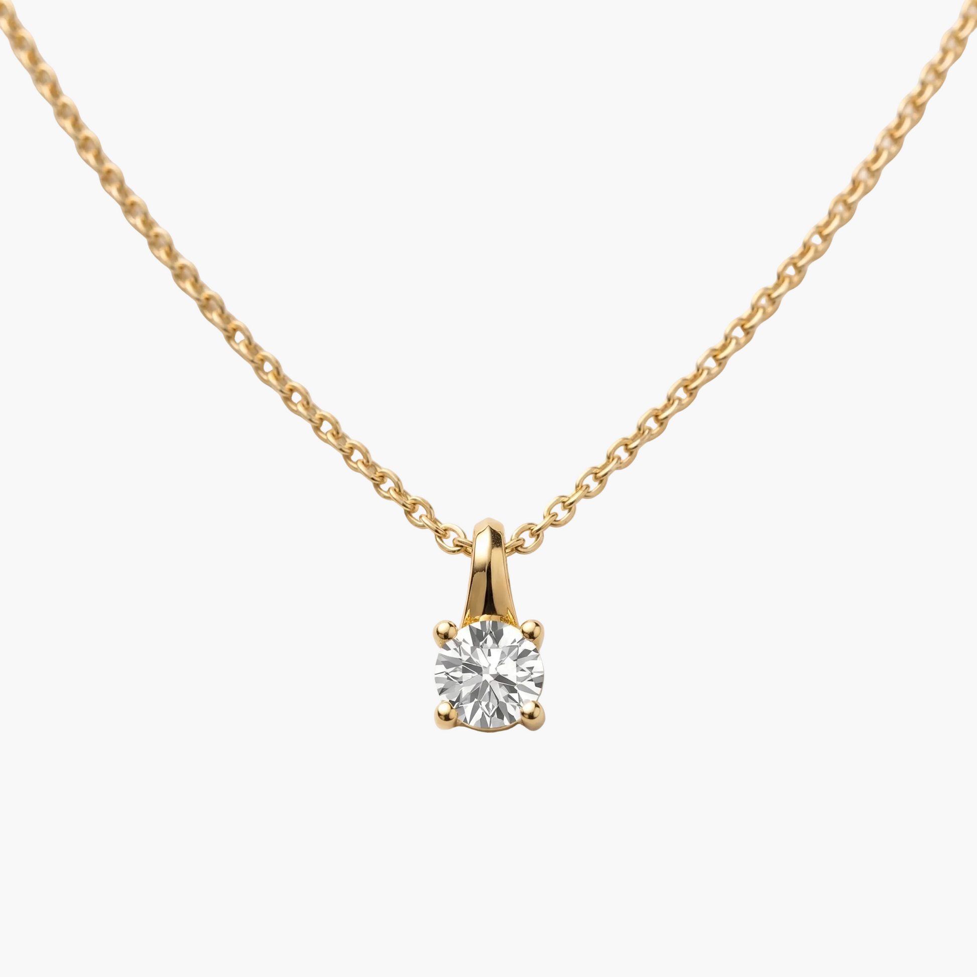 Gold necklace with a diamond pendant on a light gray background