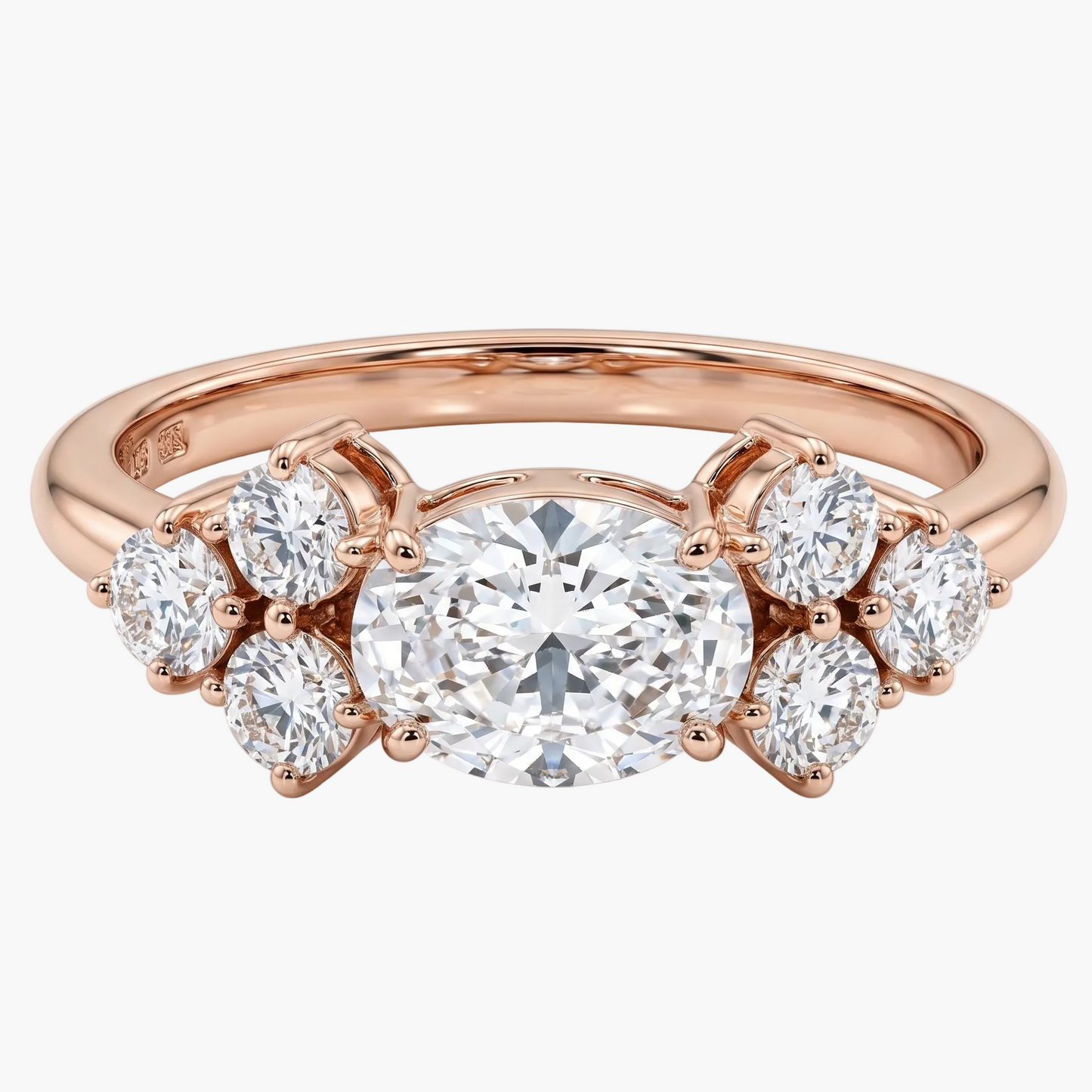 Rose gold ring with a large diamond and smaller diamonds on a white background