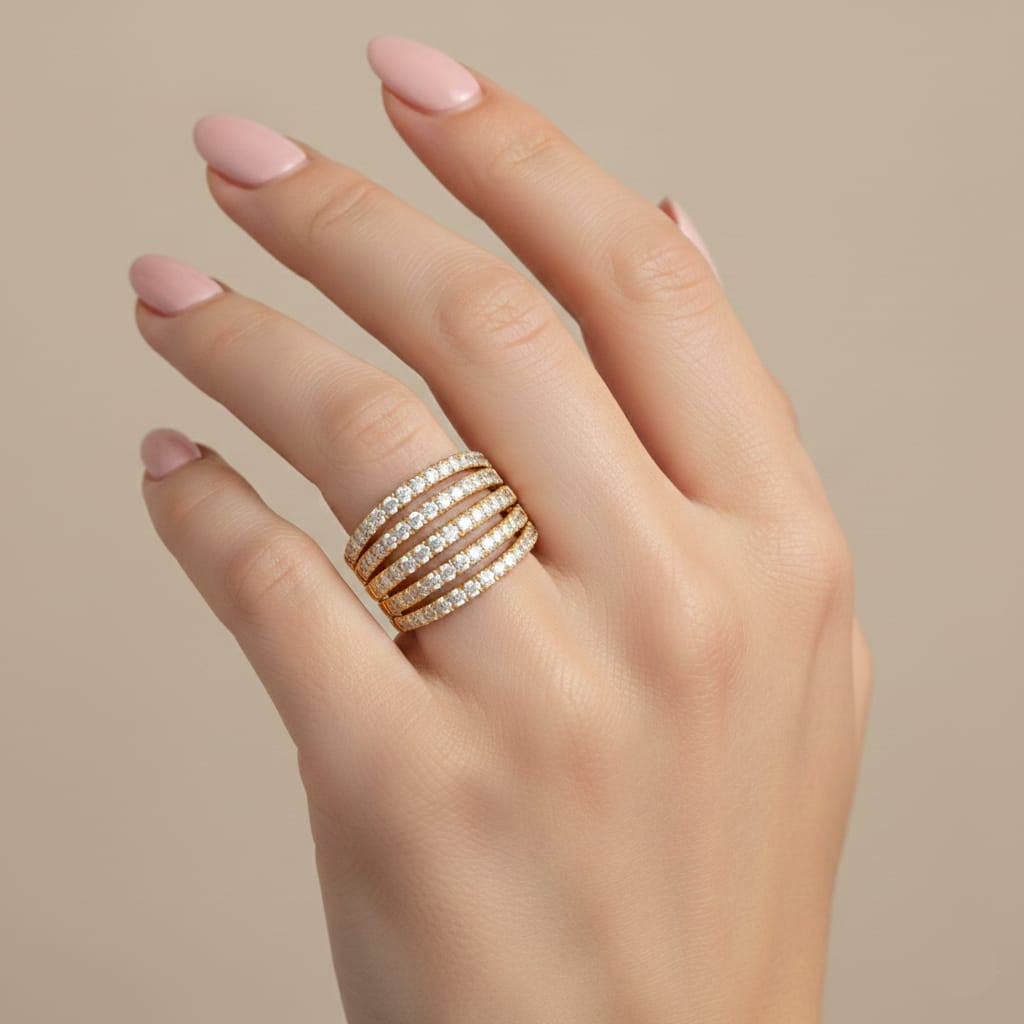 Hand wearing a stack of diamond rings on a beige background