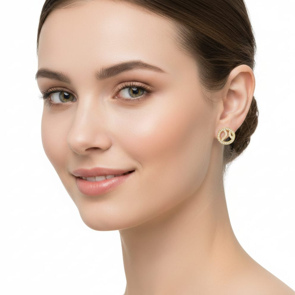 Woman wearing gold earrings on a white background