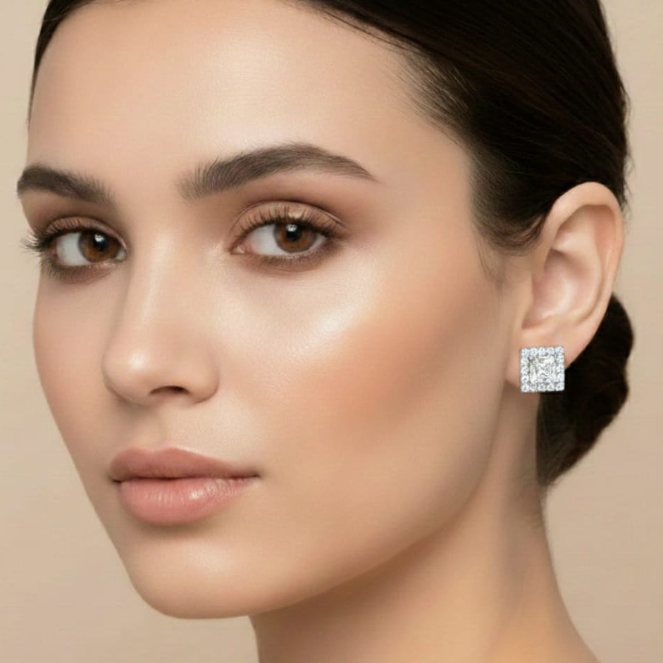 Close-up of a woman wearing diamond earrings on a beige background