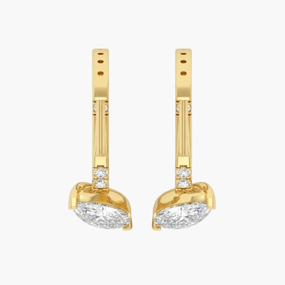 Gold earrings with clear gemstones on a white background
