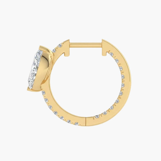 Gold hoop earring with clear gemstones on a white background