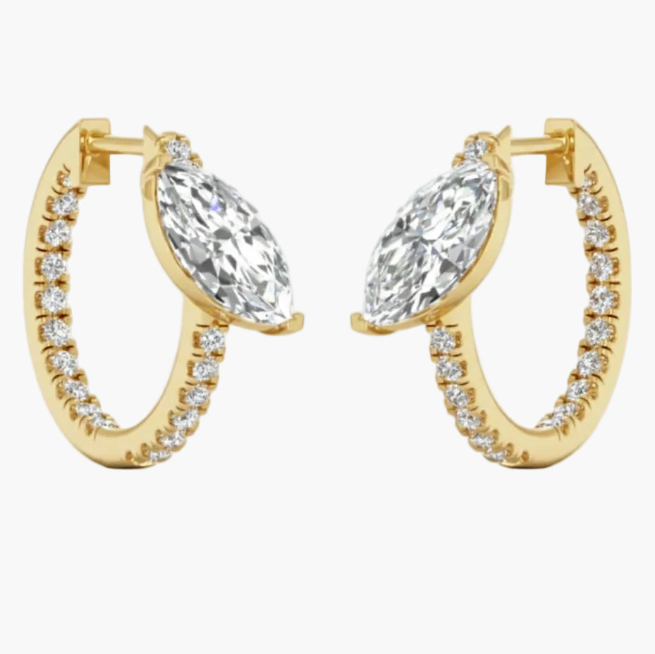 Gold hoop earrings with clear gemstones on a white background