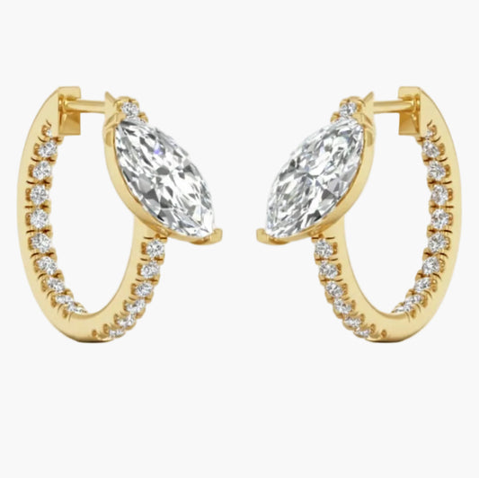 Gold hoop earrings with clear gemstones on a white background