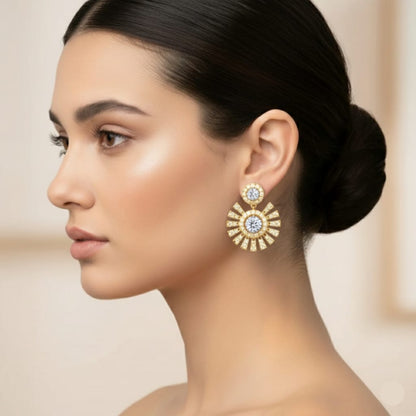 Woman wearing gold earrings with a blurred background