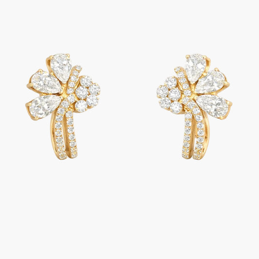 Gold earrings with diamond accents on a white background