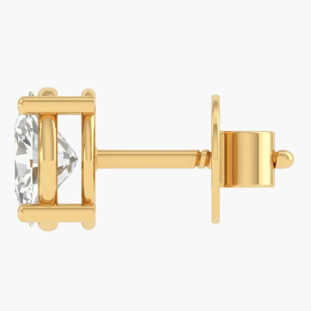Gold earring with a clear gemstone on a white background