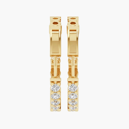Gold hoop earrings with embedded diamonds on a white background