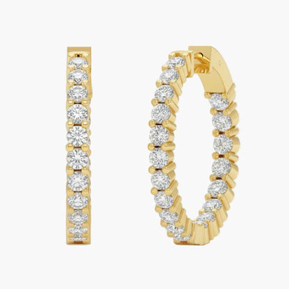 Gold hoop earrings with diamond accents on a white background