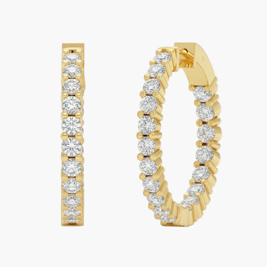 Gold hoop earrings with diamond accents on a white background