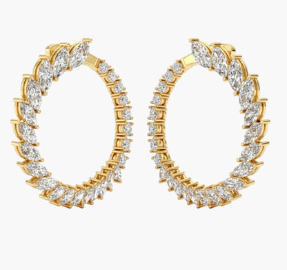 Gold hoop earrings with clear gemstones on a white background